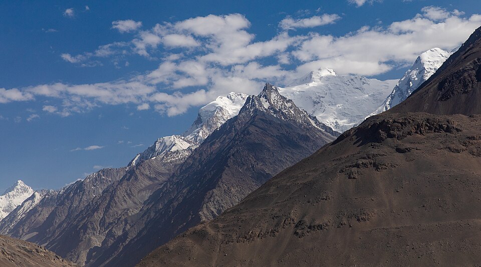 Snow-covered peaks of the Hindu Kush under a blue sky